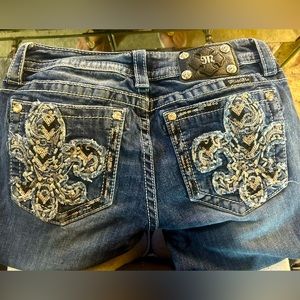 Dark jeans, silver black and baby blue design on pockets